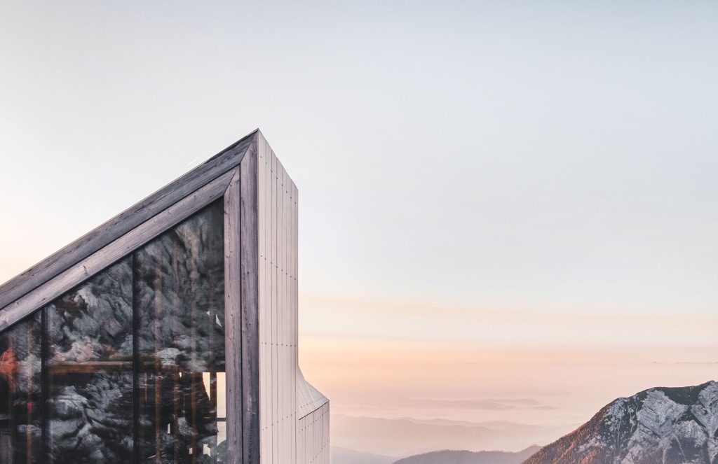 Sun setting behind a modern timber building